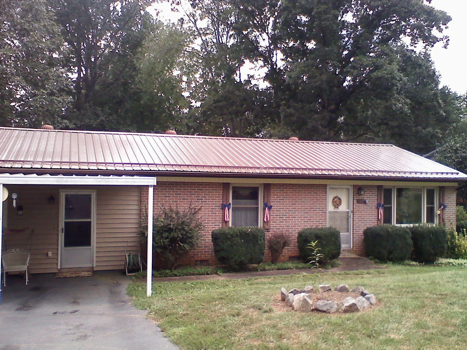 Bronze metal roof and carport on a brick ranch home — Roof Repair work by our crew in Alvarado
